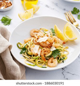 Shrimp And Zucchini Noodles Or Zoodles Pasta With Parmesan And Chili Flakes With Lemon In White Bowls