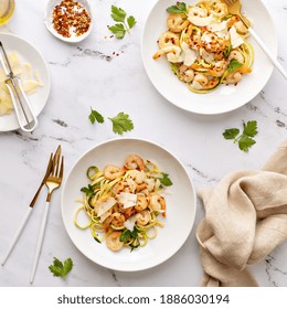 Shrimp And Zucchini Noodles Or Zoodles Pasta With Parmesan And Chili Flakes Plated In White Pasta Bowls