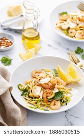 Shrimp And Zucchini Noodles Or Zoodles Pasta With Parmesan And Chili Flakes With Lemon In White Bowls