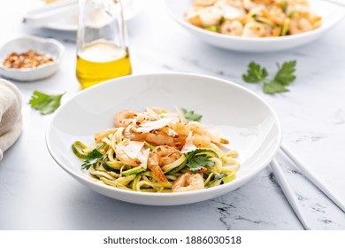 Shrimp And Zucchini Noodles Or Zoodles Pasta With Parmesan And Chili Flakes With Lemon In White Bowls