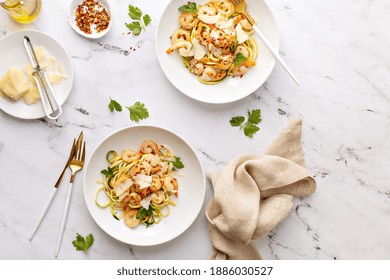 Shrimp And Zucchini Noodles Or Zoodles Pasta With Parmesan And Chili Flakes Plated In White Pasta Bowls