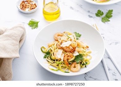 Shrimp And Zucchini Noodles Or Zoodles Pasta With Parmesan And Chili Flakes With Lemon In White Bowls