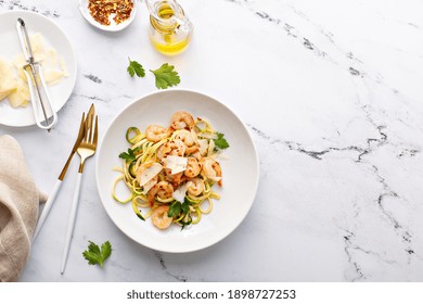 Shrimp And Zucchini Noodles Or Zoodles Pasta With Parmesan And Chili Flakes Plated In White Pasta Bowls