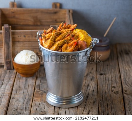 Shrimps bucket with rice isolated on wooden background side view of japanese food