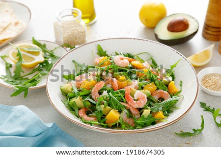 Shrimps salad with arugula, mango and avocado. Healthy food concept. Top view.