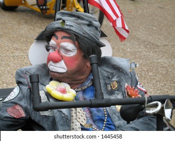 A Shriner Clown Drives His Little Cart In A Small Town Festival Parade