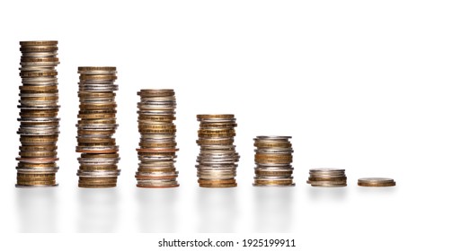 Shrinking stacks of various coins isolated on a white background