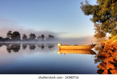 Shrouded By Mist A Secured Boat On The Bellinger River At Dawn