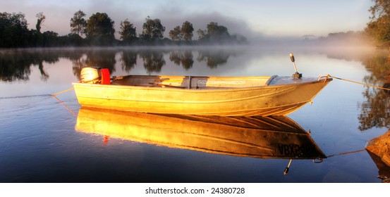 Shrouded By Mist A Secured Boat On The Bellinger River At Dawn