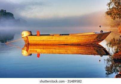 Shrouded By Mist A Secured Boat On The Bellinger River At Dawn