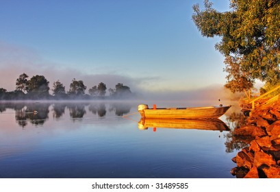 Shrouded By Mist A Secured Boat On The Bellinger River At Dawn