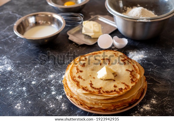 Shrovetide\
Maslenitsa festival meal. Russian pancake stack of pancakes and\
ingredients for making dough,\
Maslenitsa