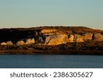 Shrubby Hill by Lake at Sunset at Jim Bridger Recreational Area