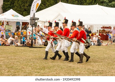 Shugborough Staffordshire 31st July 2011: Red Coat Soldiers. Male Actors Dressed As British Fusiliers Leading A Charge In Open Field.