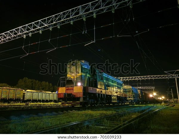 Shunting
diesel locomotive in the rail yard by
night.