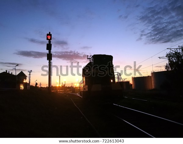 Shunting\
diesel locomotive in the rail yard by\
night.