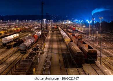 Shunting yard and Freight Station in Hagen Vorhalle Westphalia Germany with factory buildings and smokestack at morning blue hour twilight long time exposure - Powered by Shutterstock