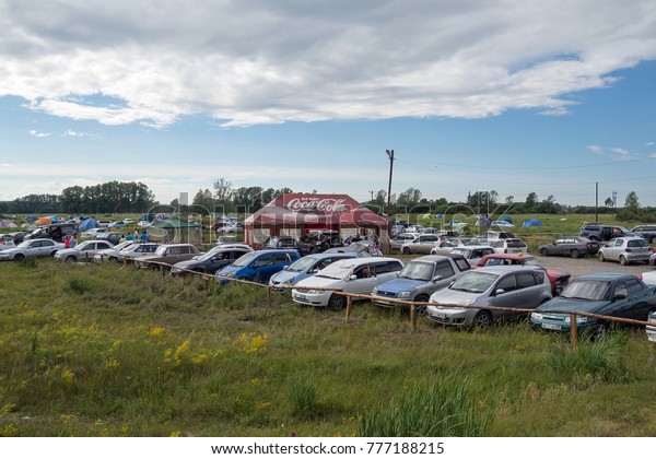 SHUSHENSKOE, RF - July 12, 2015: Organized parking for\
cars in the camping for the time of the annual Inter-Ethnic\
festival of music and crafts \