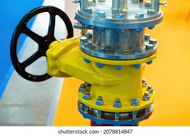 Shut-off valve on gas pipe. Fragment of pipeline with valve. Valve on pipe in boiler room. Concept - shutting off gas supply. Flap to shut off gas flow. Yellow steel pipeline close up