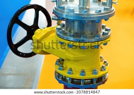 Shut-off valve on gas pipe. Fragment of pipeline with valve. Valve on pipe in boiler room. Concept - shutting off gas supply. Flap to shut off gas flow. Yellow steel pipeline close up