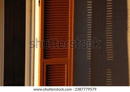 Shutters shadows and  sunset light, lines parallel 