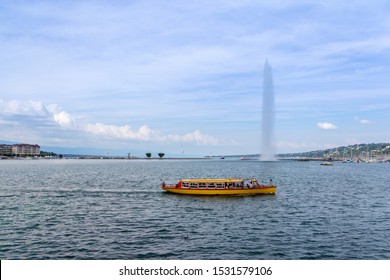 Shuttle boat transporting passengers on Lake Geneva with the Jet d'Eau fountain in the background