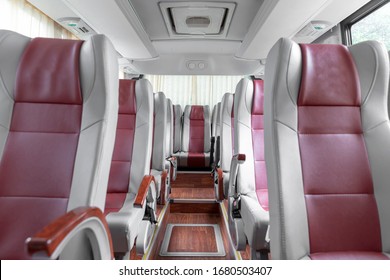 Shuttle Bus Interior With Grey And Red Leather Seat Cover, Wood Floor.