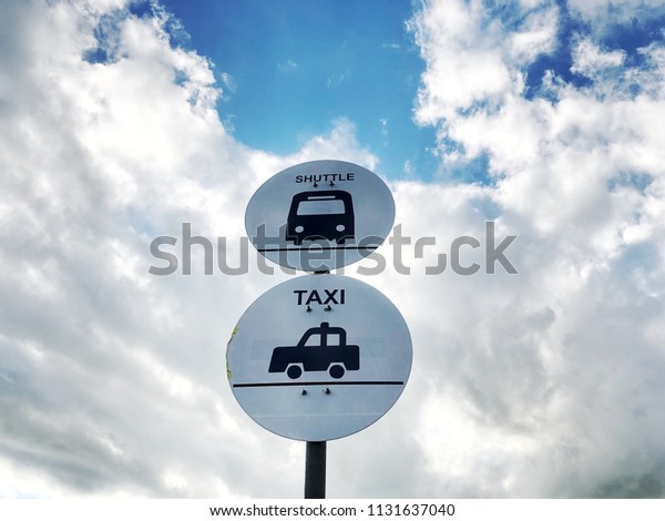 Shuttle Bus and Taxi signal isolated icon\
with blue sky and cloud\
background.