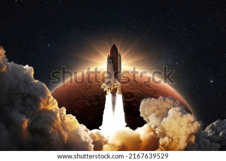 Shuttle rocket successfully takes off into space on a background of the red planet Mars with the sunrise. Spaceship with clouds of smoke and blast liftoff into stellar sky. Concept of space travel 