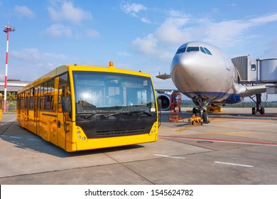 Shuttle Yellow Bus Waiting For Passengers On The Plane For Transportation To The Airport Terminal. Aircraft Arrival Background. Travel Tourist Destination Concept