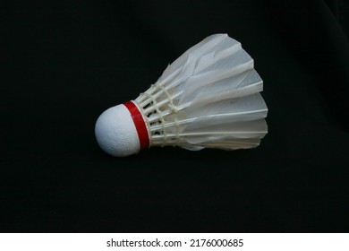 A shuttlecock or badminton ball is a ball used in badminton, made of a series of goose feathers arranged in an open cone, with a hemispherical base made of cork.