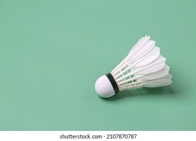Shuttlecock badminton on green background with copy space
