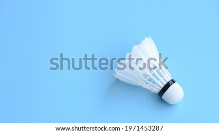 Shuttlecock (birdie) isolated on blue court background with copy space