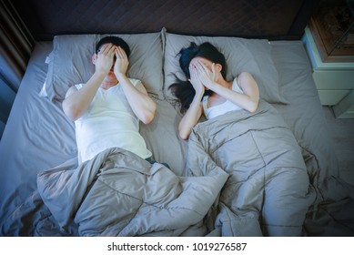 Shy Asian Couple Sleeping On Bed At Night