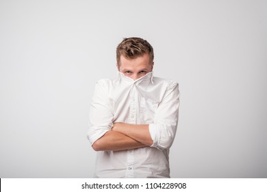 Shy caucasian man hiding behind his white shirt. Concept of being shy - Shutterstock ID 1104228908