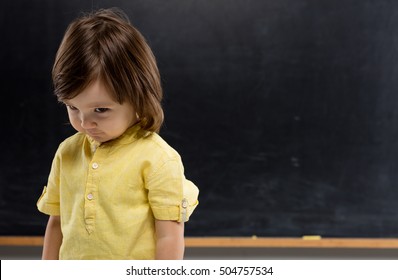 Shy Child On Blackboard.