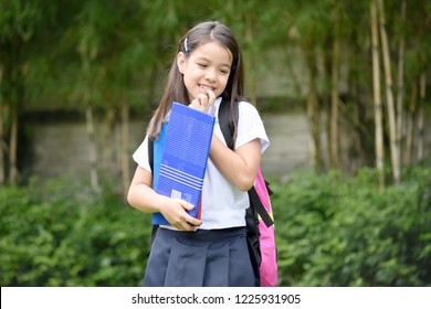 Shy Female Student With Notebooks