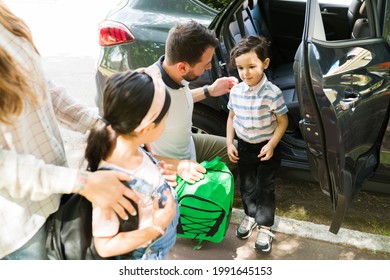 Shy Little Kid Feeling Nervous About Going To School On His First Day. Beautiful Boy With A Backpack Getting Out Of The Car With His Parents 