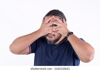 A shy or perverted man hiding his face but peeking with one eye. Isolated on a white background.