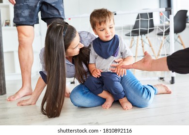 Shy Toddler Together With Mother On The Floor In The Living Room