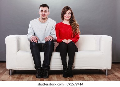 Shy Woman And Man Sitting On Sofa Couch Next To Each Other. First Date. Attractive Girl And Handsome Guy Meeting Dating And Trying To Talk.