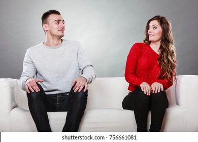 Shy Woman And Man Sitting On Sofa Couch Near Each Other. First Date. Attractive Girl And Handsome Guy Meeting Dating And Trying To Talk.