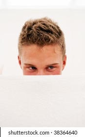 A Shy Young Man Hides His Face Behind A Towel