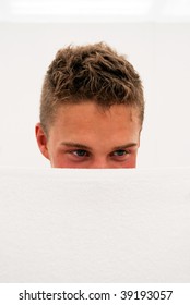 A Shy Young Man Hides His Face Behind A Towel