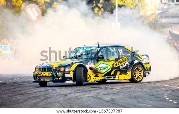 Shymkent /\
Kazakhstan - October 23, 2018: Demonstration performances cars for\
drifting on the city streets. Driving ride with drift. Smoke and\
dust from under the wheels of\
cars.
