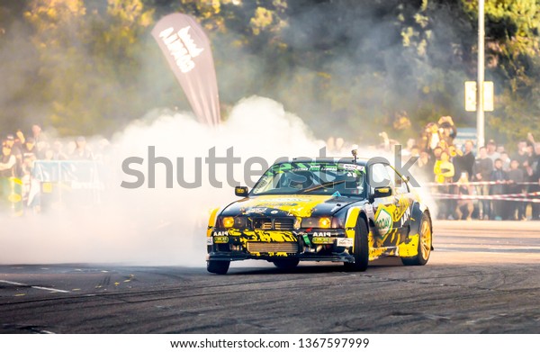 Shymkent /\
Kazakhstan - October 23, 2018: Demonstration performances cars for\
drifting on the city streets. Driving ride with drift. Smoke and\
dust from under the wheels of\
cars.