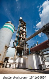 Shymkent/Kazakhstan - April 27 2012: Standard Cement Plant. Rotary Clinker Kiln, Mixing Tower, Concrete Silo And Tubes. Blue Sky Background.