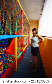SIANOZETY, POLAND - Jul 24, 2015: A Caucasian woman watching her child playing in a climb equipment in a indoor playground  - Shutterstock ID 2131173255