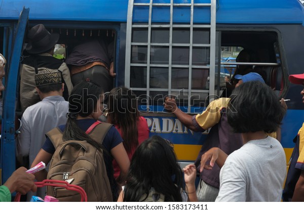 Siantar, North Sumatera-June 2019: Many\
families prepare to travel to hometown, called mudik, at Terminal\
Parluasan. Mudik is a tradition for Indonesian to go back to home\
town on big holidays.