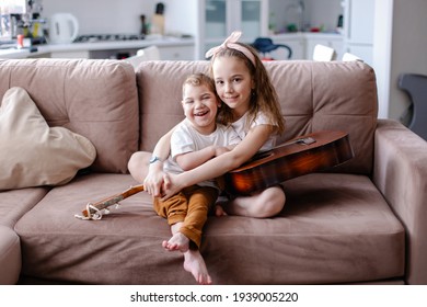 Sibling Brother And Sister Play Together. Child With Cerebral Palsy With Family In Rehabilitation. Inclusion Friendship With A Disabled Person. Music Therapy Playing The Guitar. Happy Kids Laugh Fun